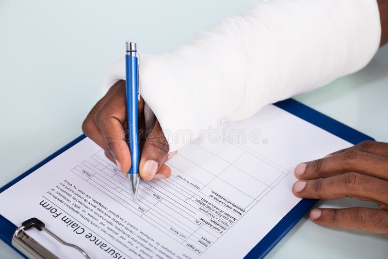 injured-man-filling-insurance-claim-form-overhead-view-bandage-hand-clipboard-147805955