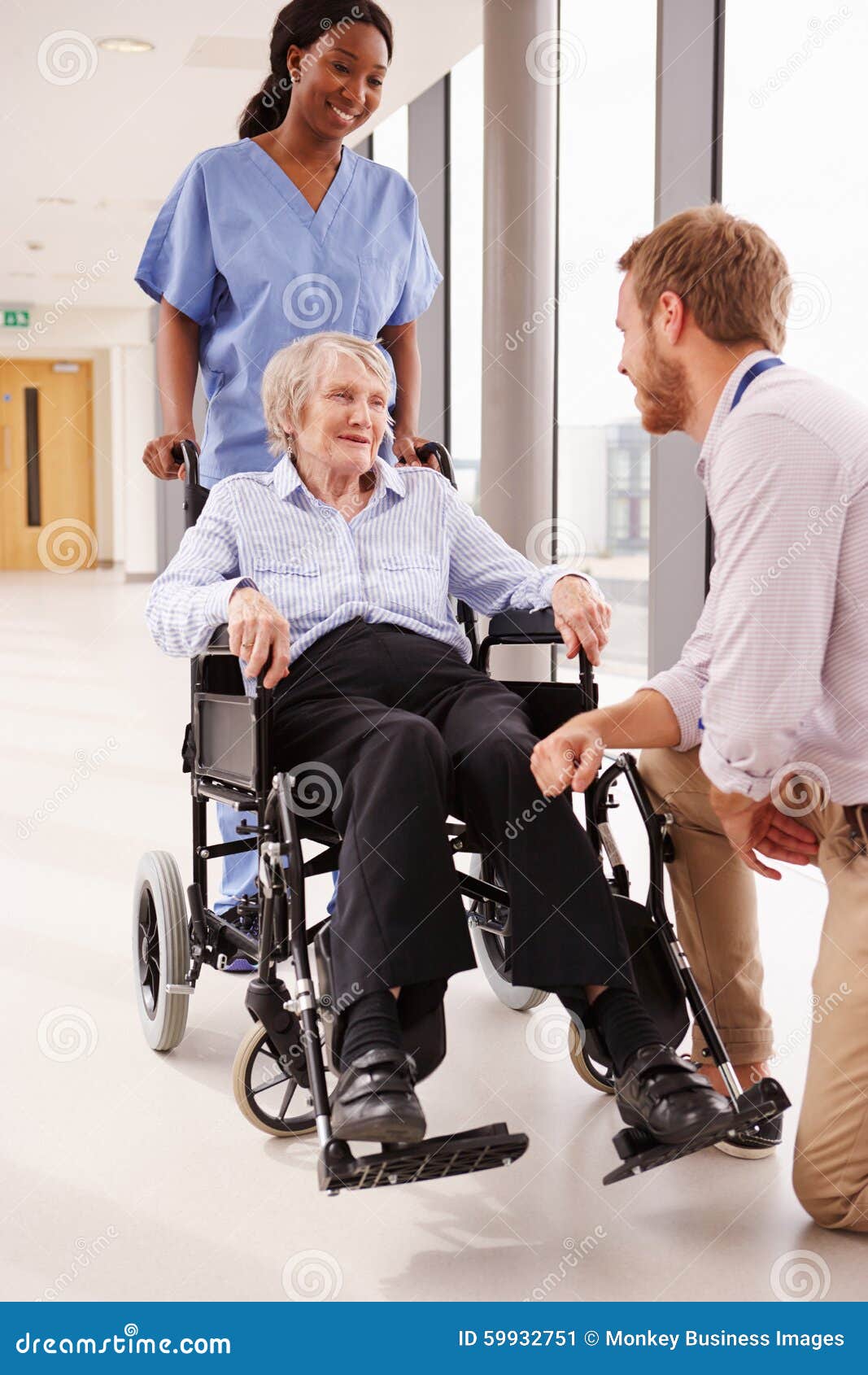 doctor-talking-to-senior-female-patient-wheelchair-59932751